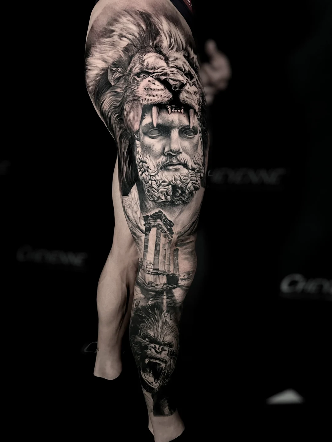 Black and grey realism statue sleeve tattoo
